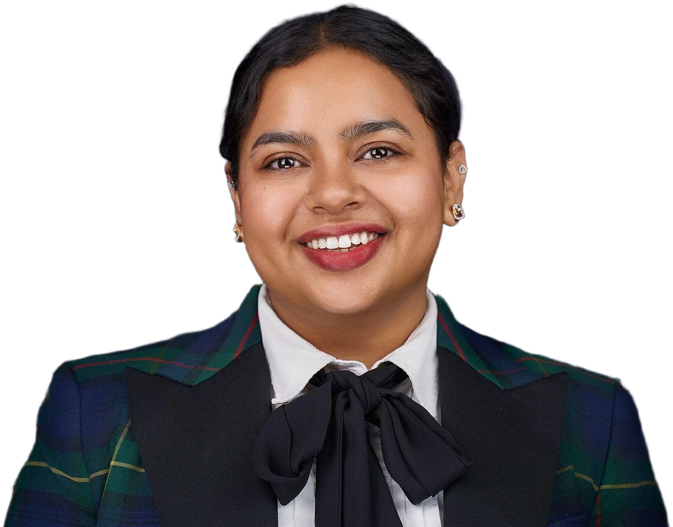 Chabi Gupta, founder of Crorepreneur, smiling, in a tartan blazer with black satin lapels, a white shirt and a black bow